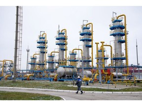 A worker passes a gas treatment unit at the Kasimovskoye underground gas storage facility, operated by Gazprom PJSC, in Kasimov, Russia, on Wednesday, Nov. 17, 2021. Russia signaled it has little appetite for increasing the natural gas it transits through other territories to Europe as the winter heating season gets underway.