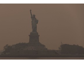 The Statue of Liberty shrouded in smoke from Canada wildfires in New York, US, on Wednesday, June 7, 2023. The US Northeast, including New York City, will continue to breathe in choking smoke from fires across eastern Canada for the next few days, raising health alarms across impacted areas.