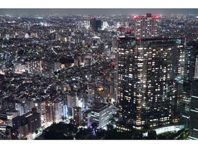 Residential buildings are illuminated at night in Tokyo, Japan, on Friday, July 21, 2023. Temperatures in central Tokyo have soared to nearly 9C (16F) above the seasonal average, as the extreme heat blanketing the world continues to smash historical norms. Photographer: Toru Hanai/Bloomberg