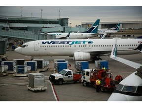 WestJet planes at Toronto Pearson International Airport in Toronto, Ontario, Canada, on Saturday, Dec. 9, 2023. The Greater Toronto Airports Authority expects a 10% increase in passenger traffic this holiday season, CBC reports.