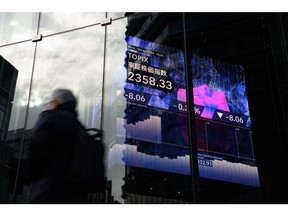 An electronic stock price board is displayed inside the Kabuto One Building in Tokyo on Thursday, Jan. 4, 2024. Japanese stocks fell on the first trading day of the year after Federal Reserve minutes showed interest rates would remain high for a long time and a strong earthquake in northwestern Japan on New Year's Day weighed on investor sentiment. Photo by Akio Kon/Bloomberg