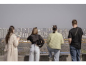 Pedestrians look across the city during air pollution from Saharan dust in Kyiv, Ukraine, on Tuesday, April 2, 2024. Dust caused by sand from the Sahara has increased the concentration of particles in the air in the Ukrainian capital. Photographer: Andrew Kravchenko/Bloomberg