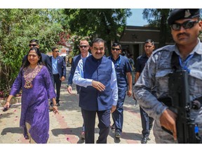 Gautam Adani and his wife Priti Adani arrive at a polling station in Ahmedabad on May 7, 2024.
