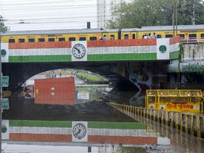 A lorry is stuck in clogged water under Minto rail Bridge after a heavy rain in New Delhi, India, Friday, June 28, 2024. (AP Photo)