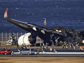 FILE - A burnt Japan Airlines plane at Haneda airport, Tokyo, Jan. 4, 2024. A Japanese transport ministry panel on Monday June 24, 2024, proposed a number of air traffic control measures to boost safety, more than six months after a fatal collision between a Japan Airlines jetliner and a coast guard plane at Tokyo's Haneda Airport. (Kyodo News via AP, File)