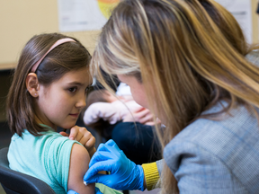 A girl receives a measles vaccine