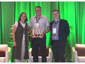 Pictured left to right: Kathy Abusow, President and CEO of SFI, presents the SFI President's Award to Lee Rueb, Forest Certification Coordinator at Mercer International, and Nick Milestone, VP of Projects and Construction at Mercer Mass Timber, at the 2024 SFI Annual Conference in Atlanta, Georgia.