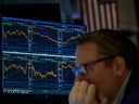 Traders work on the floor of the New York Stock Exchange as the opening bell rings in New York City.