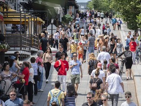 Pedestrians walk in Place Jacques-Cartier in Old Montreal, 2021.