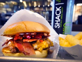 A bacon cheeseburger sandwich and fries at a Shake Shack restaurant in Chicago, Illinois.