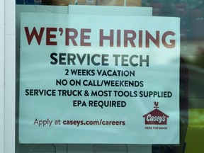 A hiring sign is displayed at a gas station in Vernon Hills, Ill., Monday, June 3, 2024. On Thursday, June 6, 2024, the Labor Department reports on the number of people who applied for unemployment benefits last week.