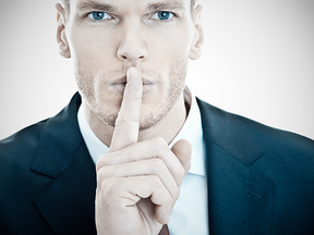 Man indicating to be quiet with finger on lips