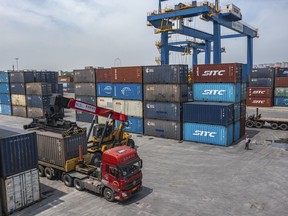 FILE - In this photo released by Xinhua News Agency, a truck transfers a container at the Tuanjiecun Station in the Chongqing International Logistics Hub Park in southwest China's Chongqing Municipality on May 5, 2024. China's exports for May beat analyst expectations despite trade tensions, though imports shrank, according to customs data released Friday, June 7, 2024.