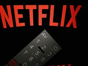 This illustration picture taken on April 21, 2018, in Paris shows the logo of the Netflix entertainment company, displayed on a tablet screen with a remote control in front of it.