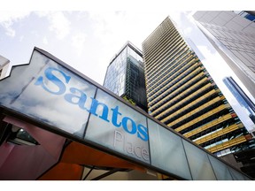 The Santos Ltd. logo displayed at an entrance of Santos Place building, which houses the company's office, in Brisbane, Australia, on Monday, Dec. 11, 2023. Woodside Energy Group Ltd.'s hopes of a tie-up with Santos to create Asia's dominant liquefied natural gas exporter face a potential hurdle over the valuation of a target whose shares recently fell to an eight-month low. Photographer: Ian Waldie/Bloomberg