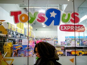 A pedestrian passes in front of a Toys "R" Us Inc. retail store in New York, U.S.
