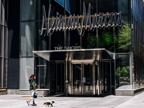 A pedestrian passes in front of a Neiman Marcus Group Inc. store in Hudson Yards, New York, U.S., 2020.