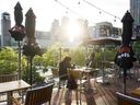 People sitting on a restaurant patio along the waterfront in Toronto, Ont.