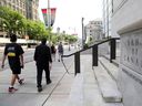 Pedestrians walk past the Bank of Canada in Ottawa.