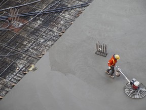 A worker smooths concrete at a housing development in Toronto, Thursday, Jan. 16, 2020.