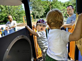 FILE - Henrik Holgersson, right, watches his son, Arvid, center with hat, play with Walter Johansson accompanied by his father Henrik Johansson at a playground in Stockholm, Sweden, Wednesday June 29, 2011. Fifty years after Sweden became the first country in the world to introduce paid parental leave for fathers, the Scandinavian country has launched a groundbreaking new law granting paid leave allowing grandparents and other legal guardians to care for a child. The law came into effect Monday, July 1, 2024, and allows parents to transfer some of their generous parental leave allowance to the child's grandparents or 'bonus-parent' -- a term often used in Sweden for a step-parent.
