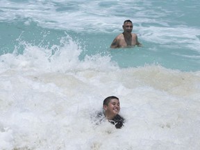Tourists swim in the ocean ahead of Hurricane Beryl's expected arrival in Cancun, Mexico, Wednesday, July 3, 2024.