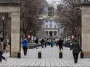 People walk through the Roddick Gates onto the campus of McGill University in Montreal on March 18, 2024.