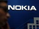 A man crossed the Nokia logo at the Mobile World Congress (MWC) held in Barcelona on February 25, 2019.