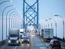 Commercial trucks and passenger vehicles drive across Ambassador Bridge on the Canada-U.S. border in Windsor, Ont. Canada's economy grew at an annualized rate of 2.1 per cent in the second quarter.
