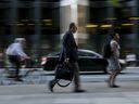 People make their way to work in Toronto's financial district.