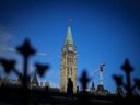 A person makes their way past the Peace Tower on Parliament Hill in Ottawa.