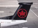 Baggage handlers unload a plane at Toronto Pearson Airport Terminal 1, August 30, 2024.