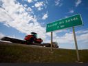 A truck drives past a Suncor Energy Inc. oilsands road sign near Fort McMurray, Alberta.