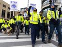 A group of striking Canada Post employees march in Montreal, Que., on Nov. 25.