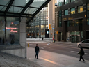 Pedestrians walk along Bay Street in the financial district of Toronto.