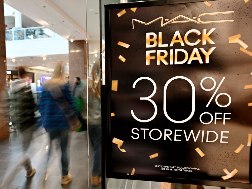 Shoppers walk past a Black Friday Sale banner at a store in a mall in Arlington, Virginia on Nov. 29, 2024.