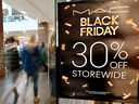 Shoppers walk past a Black Friday Sale banner at a store in a mall in Arlington, Virginia on Nov. 29, 2024.
