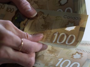 Canadian $100 bills are counted in Toronto, Feb. 2, 2016.