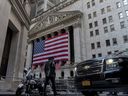 An NYPD officer walks outside of the New York Stock Exchange on Dec. 12, 2024, in New York.