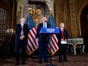 U.S. President-elect Donald Trump, flanked by SoftBank CEO Masayoshi Son, right, and Trump's choice for Secretary of Commerce, Cantor Fitzgerald Chairman and CEO Howard Lutnick, speaks at a news conference at Mar-a-Lago this week.