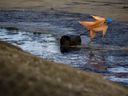 A scarecrow, used to deter birds from landing, in the Suncor Energy Inc. tailings pond in the oil sands near Fort McMurray, Alta.