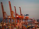 Ships unload in the Port of Vancouver. Overall, 10 out of the 12 sectors of Canada's economy expanded.