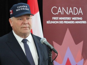 Ontario Premier Doug Ford wears a 'Canada is not for sale' hat to meetings with the country's premiers in Ottawa.