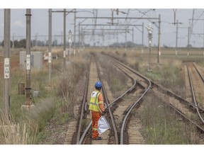 A worker prepares to signal on the train tracks on the central corridor rail freight line, between Sentrarand depot and Pyramid South depot, in Gauteng, South Africa, on Friday, Nov. 17, 2023. Volumes of goods and commodities, including iron ore and coal shipped through the Transnet's freight rail network for export, have dropped because of issues including vandalism, idle locomotives and cable theft. Photographer: Guillem Sartorio/Bloomberg