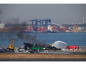 The wreckage of a Japan Airlines passenger jet that collided with a Japan Coast Guard plane at Haneda Airport, on Jan. 5. Photographer: Akio Kon/Bloomberg
