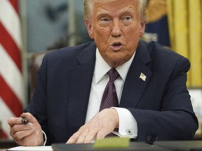 President Donald Trump talks as he signs executive orders in the Oval Office of the White House, Monday, Jan. 20, 2025, in Washington.
