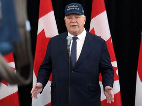 Ontario Premier Doug Ford, wearing a 'Canada Is Not For Sale' hat, arrives for a first ministers meeting in Ottawa on Jan. 15.