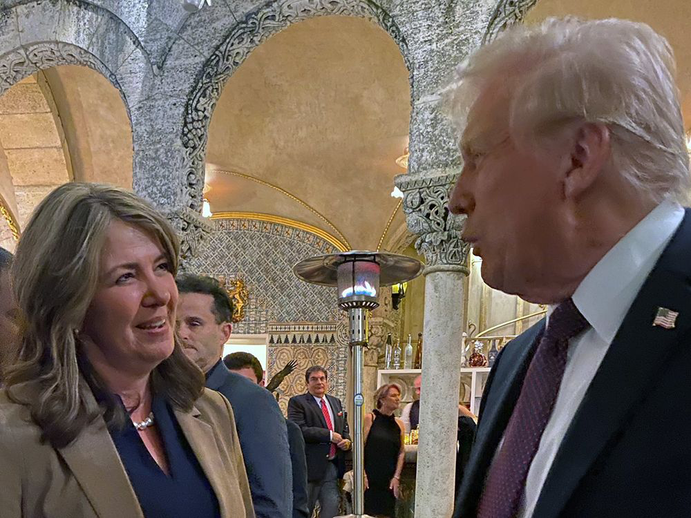 Alberta Premier Danielle Smith speaks with Donald Trump at his Mar-a-Lago resort over the weekend.