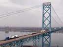 In this aerial view, trucks cross the Ambassador Bridge as they carry cargo between Canada and the United States on February 03, 2025 in Detroit, Mich.