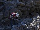 A worker inspects graphite ore at the Nouveau Monde Graphite Matawinie Mine in Saint-Michel-des-Saints, Quebec, Canada, on Oct. 6, 2022.